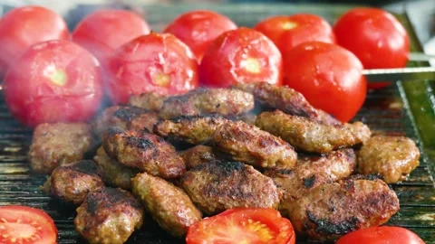 Meatballs and tomatoes on a grill Stock Footage 242425937
