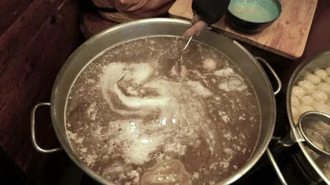 Meatballs float in the pot to make noodles Thai Food. Stock Footage 140564307