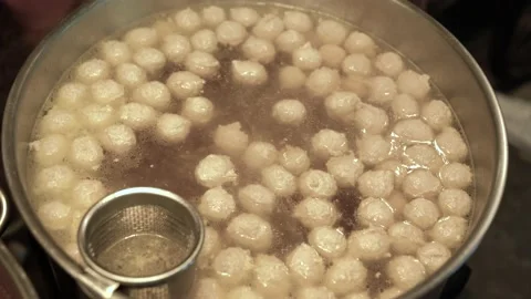 Meatballs float in the pot to make noodles Thai Food. Stock Footage 140564559