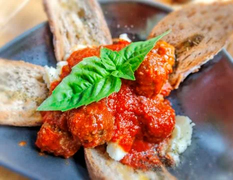 Meatballs in a plate with bread on table Stock Photos