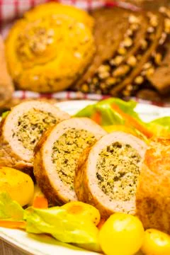 Meatloaf with spinach stuffing served with fried potatoes and carrot. Stock Photos