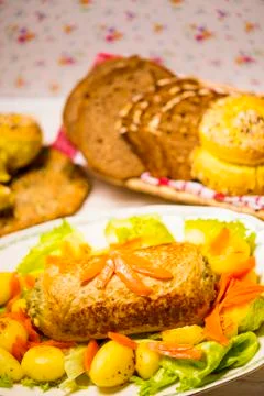 Meatloaf with spinach stuffing served with fried potatoes and carrot. Stock Photos