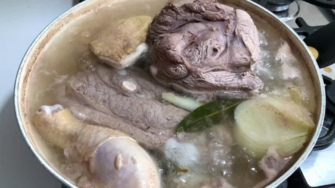 Meats, beef and chicken, boiling in a pot for the traditional Italian bollito. Stock Footage 86693483