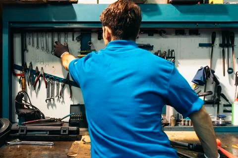 Mechachical worker take tool in Garage Stock Photos