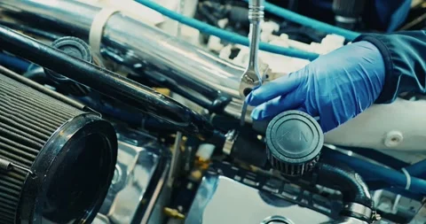 Mechanic Adjusting Engine Parts in Workshop Видео 323765801