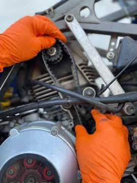 Mechanic Adjusting Motorcycle Engine Stock Photos