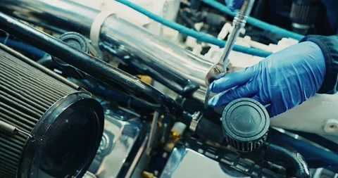 Mechanic Adjusts Engine Components in Workshop 스톡 동영상 323765706