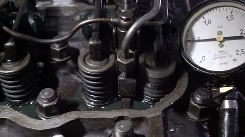 The mechanic adjusts the valve on the diesel engine. Arrow of the manometer Stock Footage 75050645