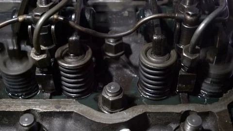 The mechanic adjusts the valve on the diesel engine Stock Footage 75050985