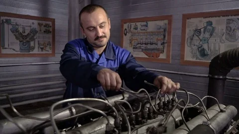 The mechanic adjusts the valve on the diesel engine. In hands tools Video stock 75076908