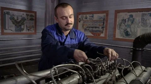 The mechanic adjusts the valve on the diesel engine. In hands tools Video stock 75076980