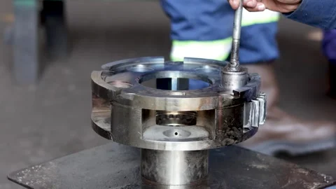Mechanic Aligning Spindle Pin in Planetary Carrier Using Screwdriver Tool. Stock Footage 344545786