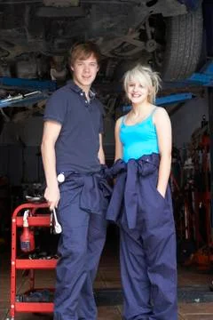 Mechanic and apprentice working on car Stock Photos