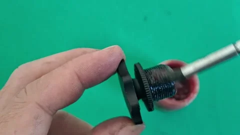 Mechanic applying red lubricating grease to threaded knob video motion Stock Footage 339091173