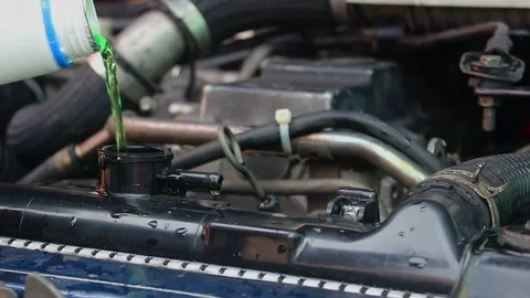 Mechanic Are adding coolant to the car Stock Footage 88182707