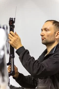 Mechanic assembling a bicycle frame in a workshop Stock Photos