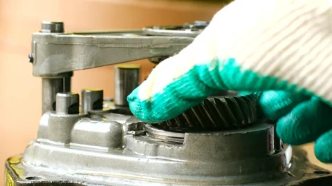 Mechanic assembling car automatic transmission gearbox Stock Footage 321739623