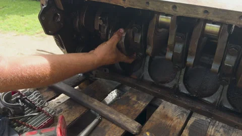 Mechanic assembling car engine crankshaft in workshop Stock Footage 338410762