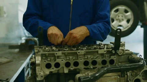 Mechanic Assembling Car Engine Cylinder Block In Auto Repair Workshop Stock Footage 345016327