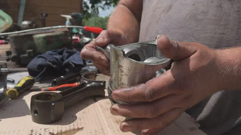 Mechanic assembling car engine piston and connecting rod Stock Footage 338411165