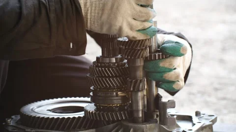 Mechanic assembling car transmission gearbox system Stock Footage 321739074