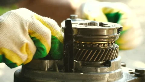 Mechanic assembling gearbox components for manual car transmission Stock Footage 314891046