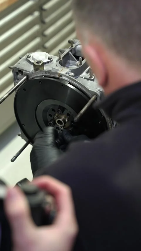 Mechanic Attaches Flywheel to High-Performance Car Engine with Precision Care Stock Footage 322891463