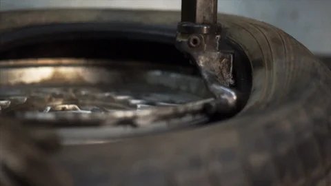 Mechanic balancing wheel with machine balancer at service. Stock Footage 99930824