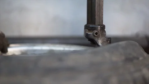 Mechanic balancing wheel with machine balancer at service. Stock Footage 99930955