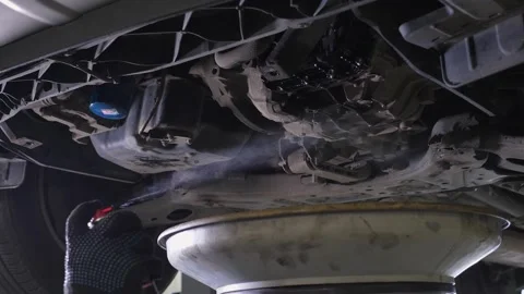 A a mechanic blowing air through the engine after changing the engine oil. Stock Footage 340245543