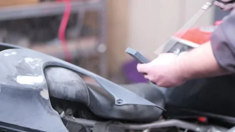 Mechanic Blowing Dust from Sanded Body Panel with Compressed Air Stock Footage 331675258