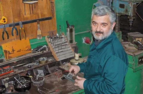 Mechanic with calliper in his workshop Stock Photos