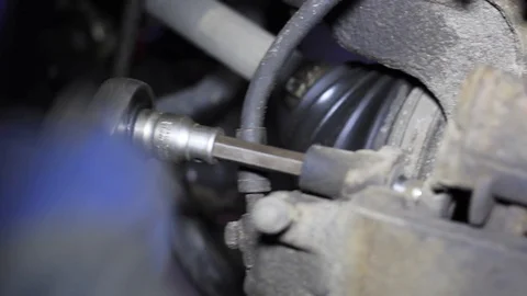 Mechanic for car checking brake system in a car at garage Stock Footage 103543414