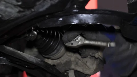 Mechanic for car checking brake system in a car at garage Stock Footage 103858667