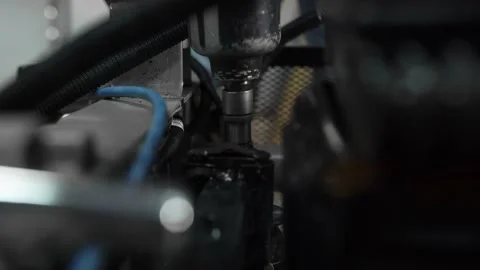 Mechanic in car workshop, with an automatic screwdriver unscrews the system unit Stock Footage 156385074