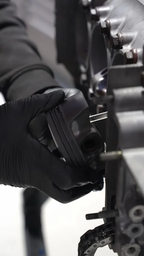 Mechanic Carefully Fits Piston to Con Rod in Engine Assembly Stock Footage 322892205