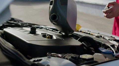Mechanic carefully pours fluid under hood car reliable functioning engine Video stock 274102901