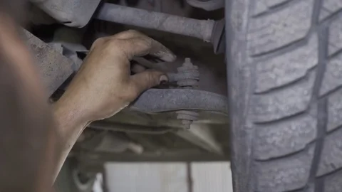 Mechanic changes the boot in the chassis of the car closeup Video stock 126110718