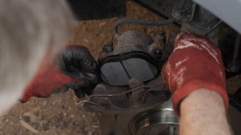 Mechanic changes brake parts in the car Video stock 108976735