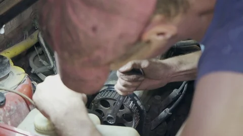 The mechanic changes the timing belt in the car close-up Stock Footage 110863259