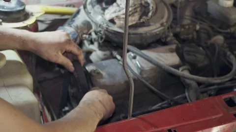 Mechanic changes the timing belt in the old car close-up Stock Footage 110863316