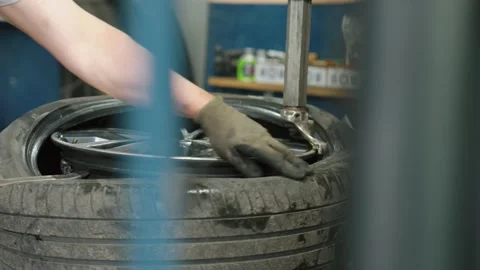 Mechanic changing car tire in an auto repair shop Stock Footage 337829584