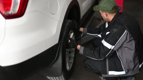 Mechanic Changing Car Tire Stock Footage 302366088