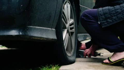 Mechanic changing flat tire Stock Footage 250111759