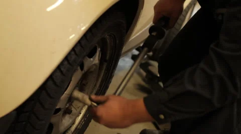 Mechanic changing a wheel Stock Footage 63547341