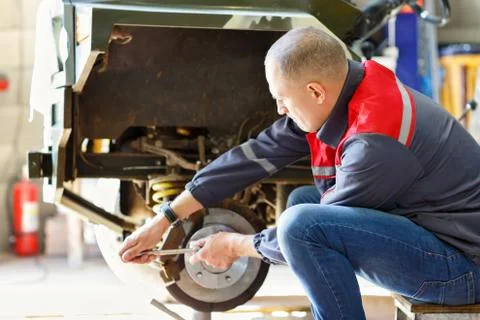 Mechanic changing wheel Stock Photos