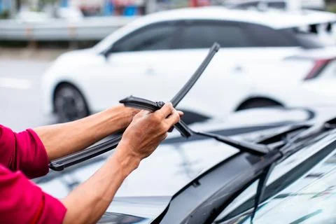 The mechanic is changing the windshield wiper rubber. Replacing worn-out wi.. Stock Photos