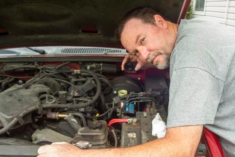 Mechanic Checking The Brake Fluid In A Master Cylinder Stock Photos