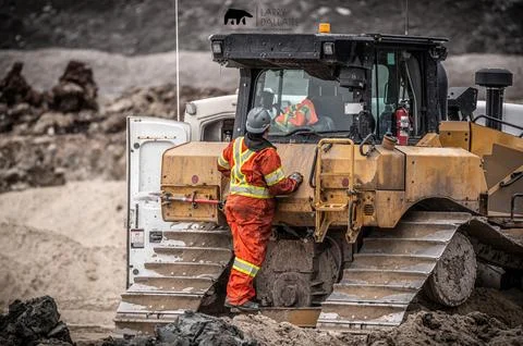 Mechanic checking a bulldozer Stock Photos