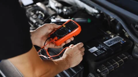Mechanic Checking Car Battery with Multimeter Stock Footage 315145073